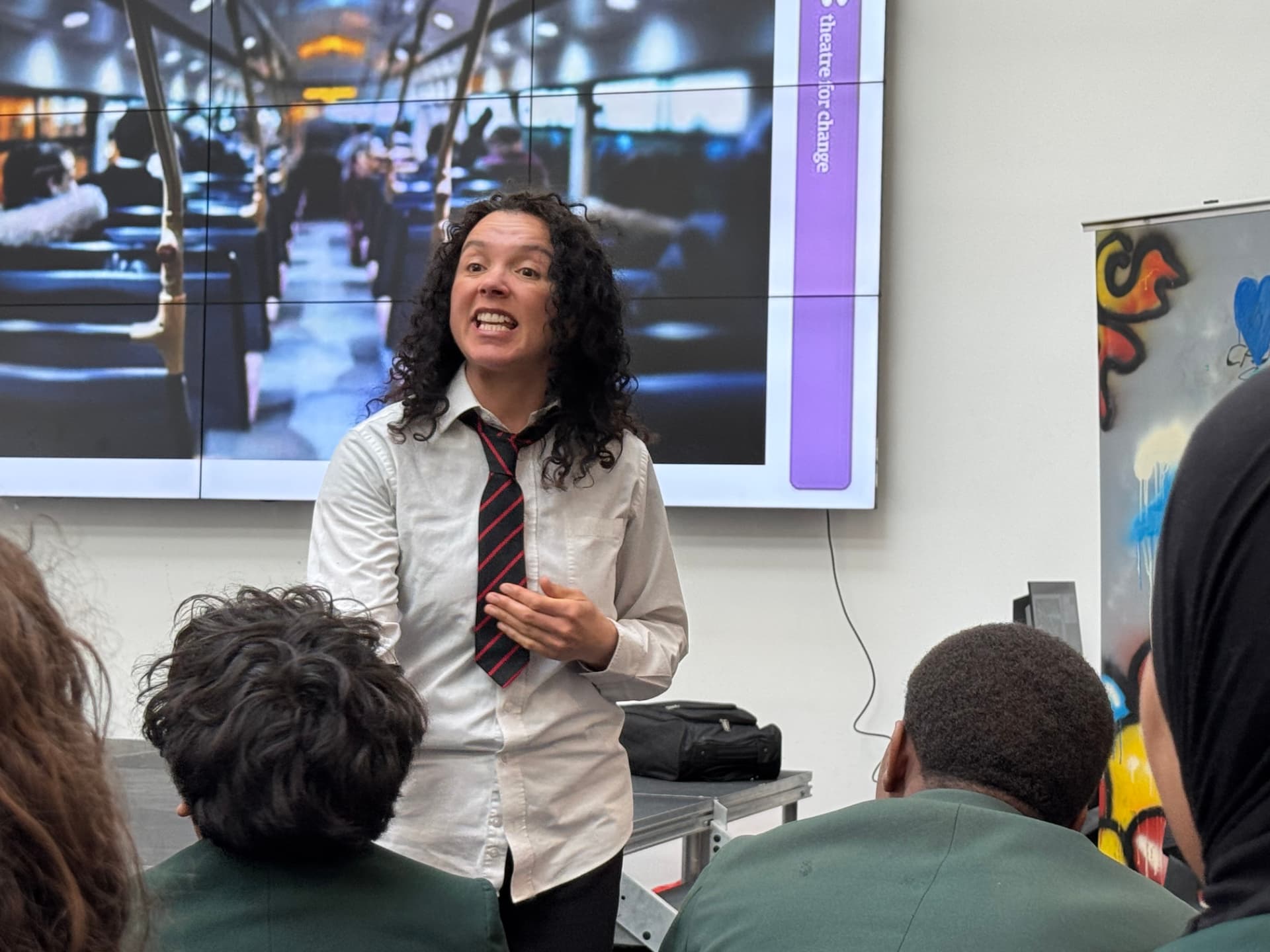 Actor in school uniform performing an intense monologue during Time's Up!