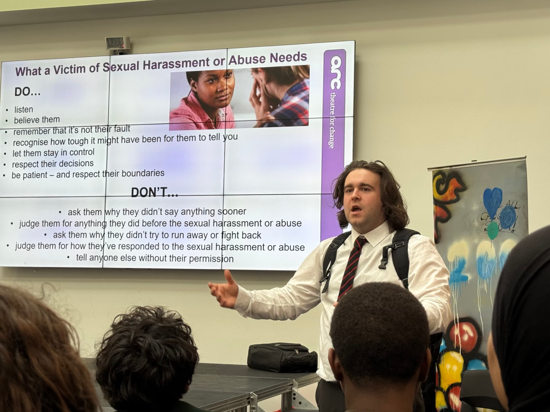 Actor leading a Time's Up! workshop slide about supporting victims of sexual harassment